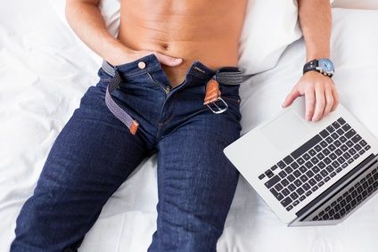 Male masturbating while using computer